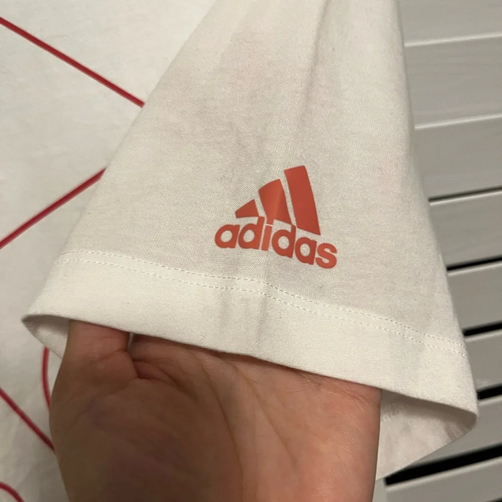 Size M, Adidas, white T-Shirt with red outlined logo letters